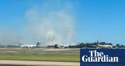 Qantas flight makes emergency landing at Sydney airport after engine failure, sparking grass fire near runway